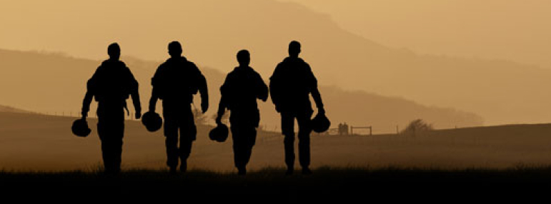 Military solidiers walking along mountain line